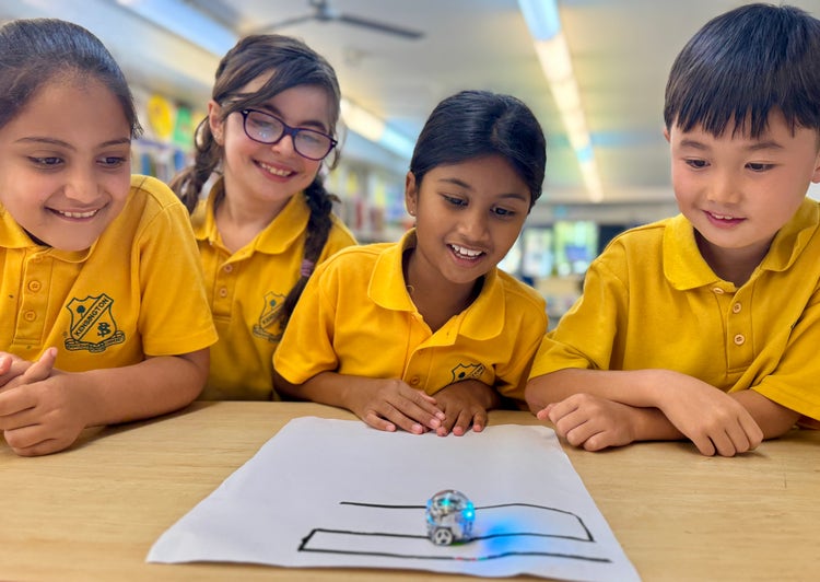 Students playing with a robot